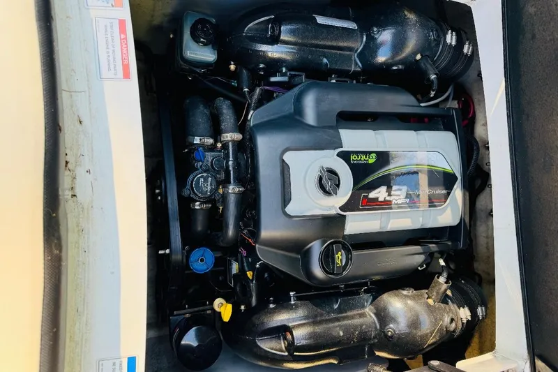 Slide: The Image of Engine compartment of a 2013 Sea Ray 190 Sport boat, featuring a 4.3L MerCruiser engine. - 9