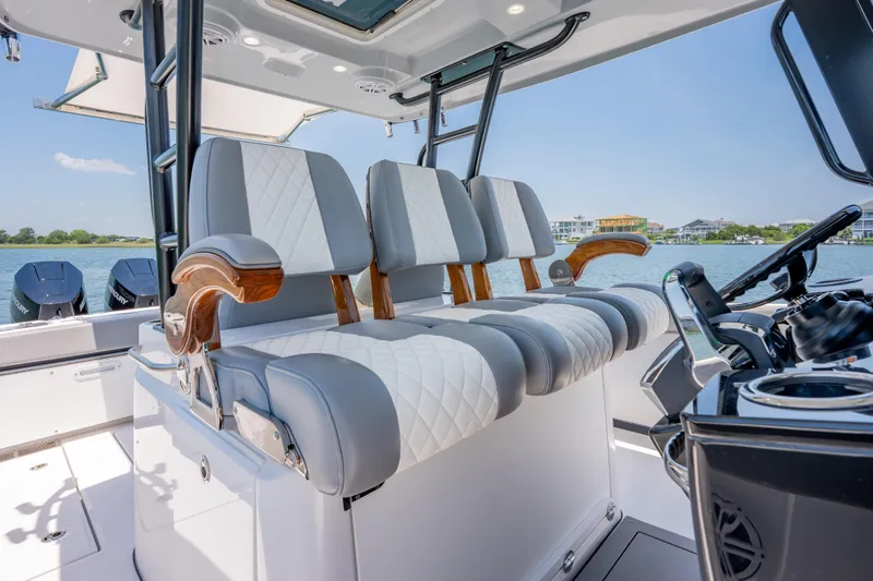 Slide: The Image of 2026 Everglades 375 Center Console boat interior with luxurious seating and modern controls. - 13