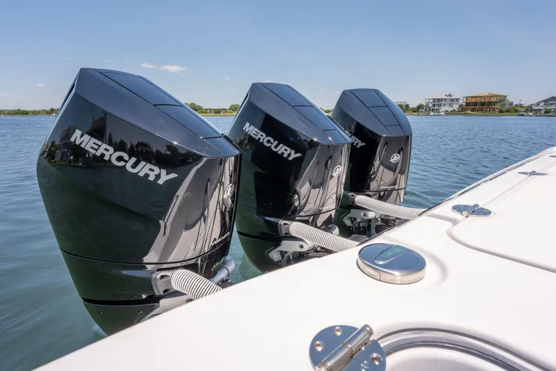 Slide: The Image of Triple Mercury outboard engines on a 2026 Everglades 375 Center Console boat. - 18