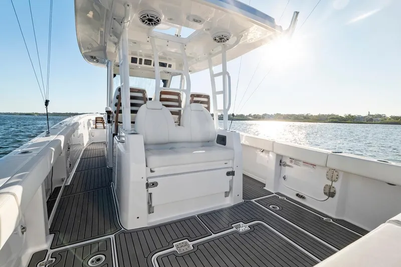 Slide: The Image of 2026 Everglades 375 Center Console boat interior with seating, on a sunny day. - 14