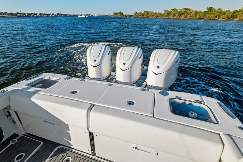 Slide: The Image of 2026 Everglades 375 Center Console boat with triple engines on open water. - 18