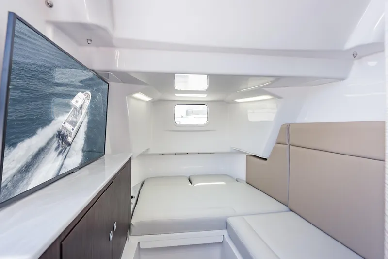 Slide: The Image of Interior cabin of 2026 Everglades 375 Center Console with seating and window. - 21
