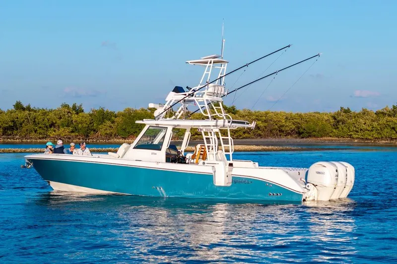 Slide: The Image of 2026 Everglades 375 Center Console boat cruising on blue water with fishing rods. - 4