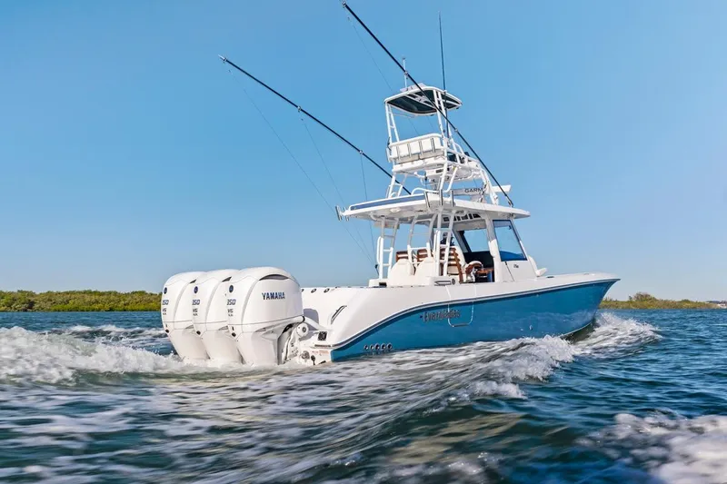 Slide: The Image of 2026 Everglades 375 Center Console boat cruising on open water, powered by Yamaha engines. - 6