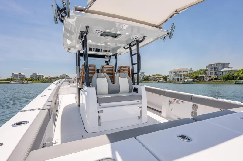 Slide: The Image of 2026 Everglades 375 Center Console boat on water, showcasing sleek design and luxury seating. - 6