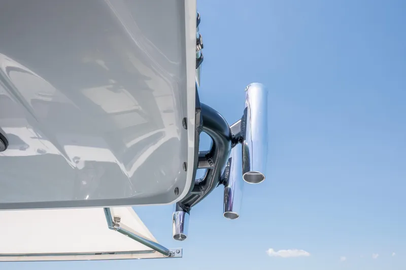 Slide: The Image of Close-up of Everglades 375 Center Console boat exhaust pipes, 2026 model, against blue sky. - 15