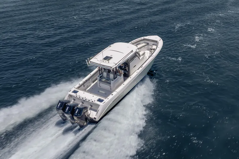 Slide: The Image of 2026 Everglades 375 Center Console boat cruising on open water. - 2
