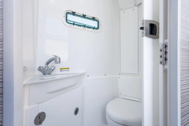 Slide: The Image of Interior of 2026 Everglades 375 Center Console boat bathroom with sink and toilet. - 24