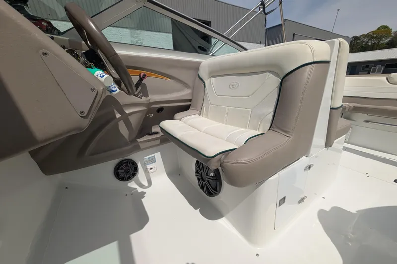 Slide: The Image of Interior of a 2000 Cobalt 292 boat featuring beige seating and steering area. - 10