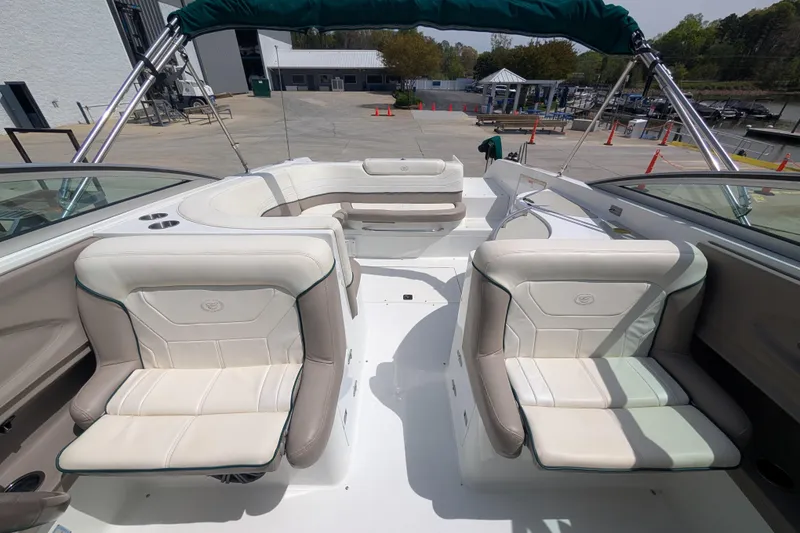 Slide: The Image of Interior of a 2000 Cobalt 292 boat with white leather seating and green accents. - 11