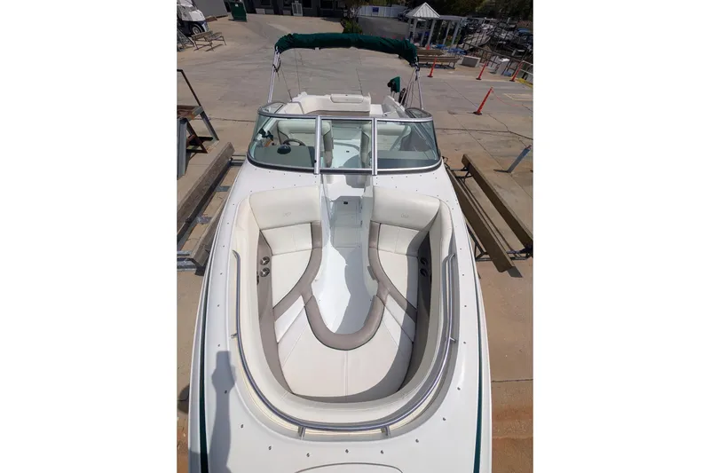 Slide: The Image of 2000 Cobalt 292 boat with white seating, docked on concrete surface. - 12