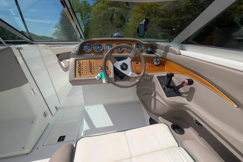 Slide: The Image of Interior of a 2000 Cobalt 292 boat, featuring a sleek dashboard and steering wheel. - 15