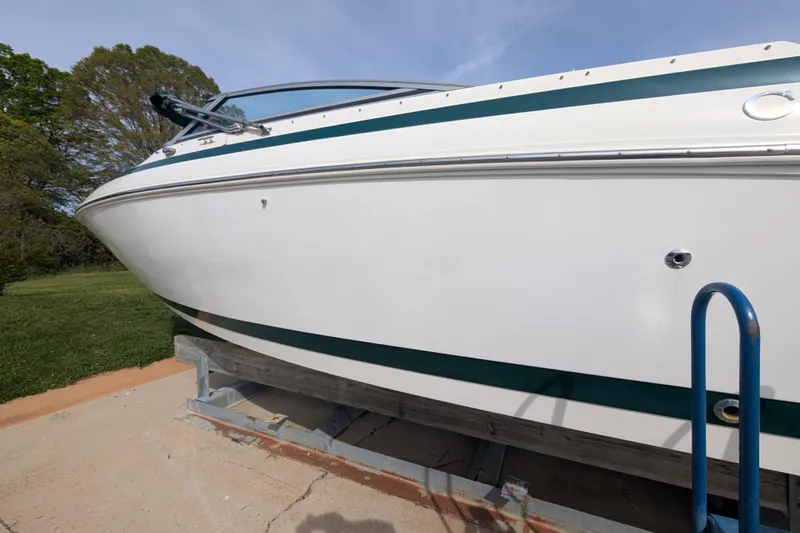 Slide: The Image of 2000 Cobalt 292 boat on a trailer, parked outdoors on a sunny day. - 18
