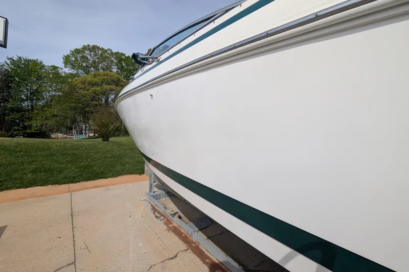 Slide: The Image of Cobalt 292 boat from 2000 on a trailer, parked on a driveway. - 19