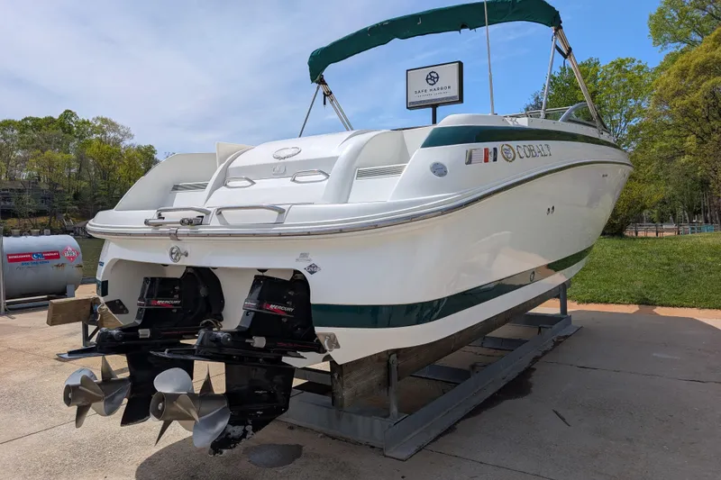 Slide: The Image of 2000 Cobalt 292 boat on trailer, dual Mercury engines, green and white design. - 3