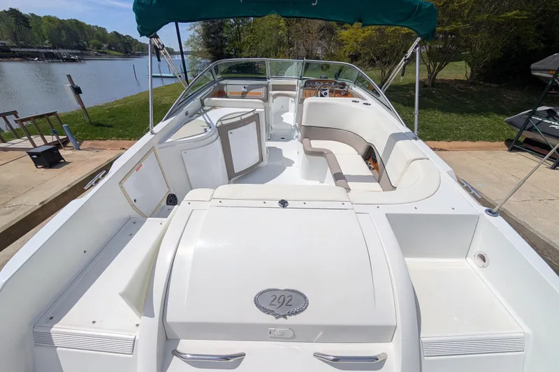 Slide: The Image of Cobalt 292 boat from 2000, docked by a scenic lakeside. - 6