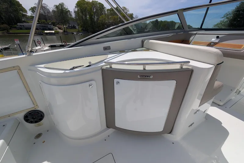 Slide: The Image of Interior of a 2000 Cobalt 292 boat, featuring sleek white seating and storage compartments. - 8