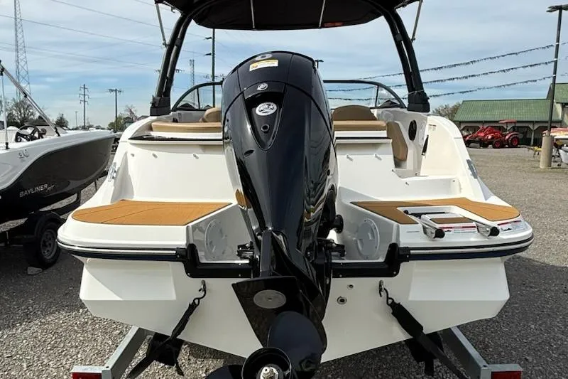 Slide: The Image of 2026 Bayliner V20 boat with powerful outboard motor, displayed outdoors. - 3