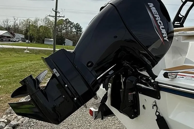 Slide: The Image of 2026 Bayliner V20 boat with a Mercury outboard motor, parked outdoors. - 4