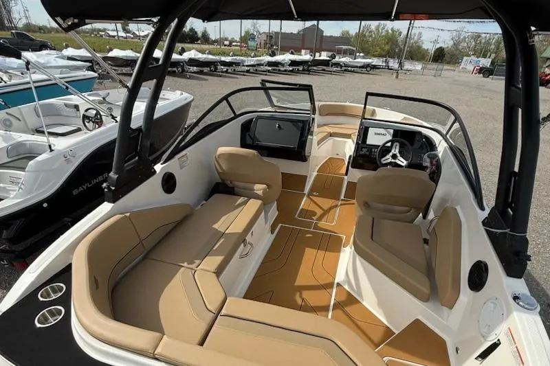 Slide: The Image of 2026 Bayliner V20 boat interior with tan seating and modern dashboard. - 6