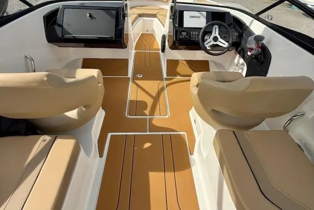 Slide: The Image of 2026 Bayliner V20 boat interior with tan seating and modern dashboard. - 7