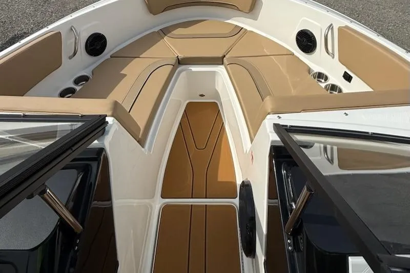 Slide: The Image of 2026 Bayliner V20 boat interior with tan seating and cup holders. - 9