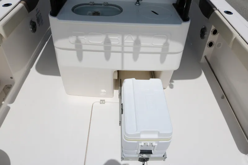 Slide: The Image of 2021 Robalo R272 Center Console boat interior with cooler and storage area. - 15