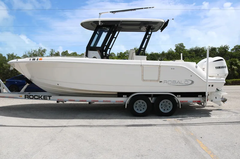 Slide: The Image of 2021 Robalo R272 Center Console boat on trailer, side view. - 2