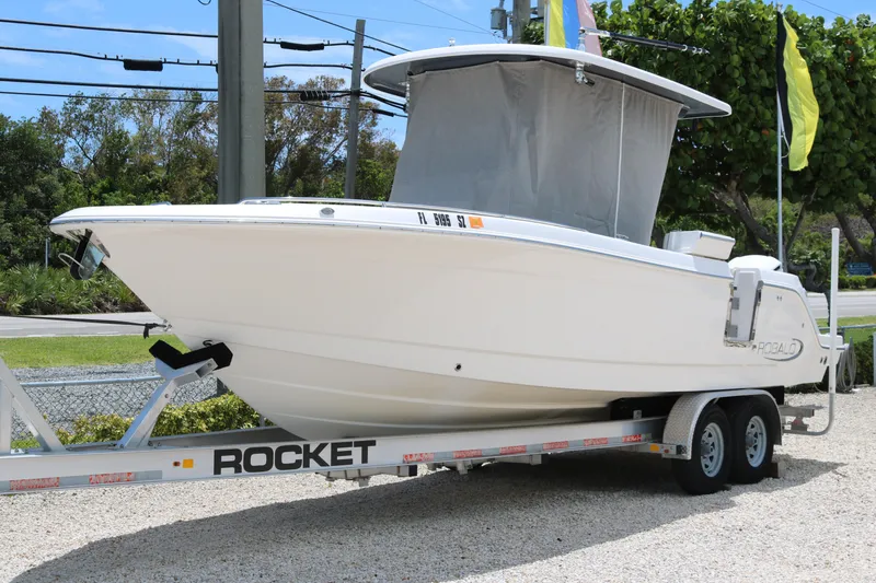 Slide: The Image of 2021 Robalo R272 Center Console boat on trailer, parked outdoors. - 20
