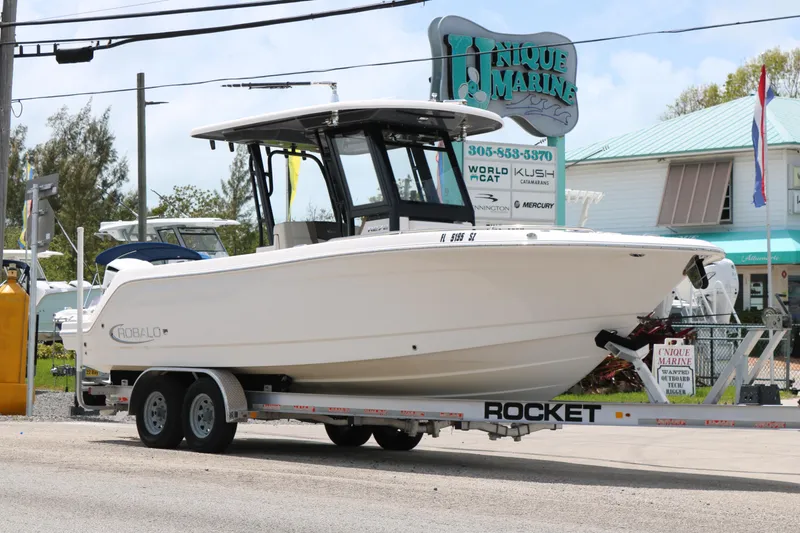Slide: The Image of 2021 Robalo R272 Center Console boat on trailer at Unique Marine dealership. - 3