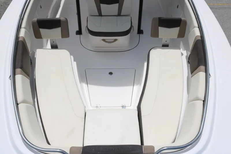 Slide: The Image of 2021 Robalo R272 Center Console boat interior with cushioned seating and storage. - 9