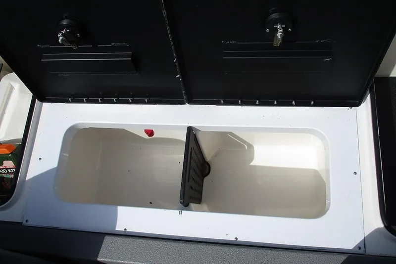 Slide: The Image of Open storage compartment in 2021 Vexus AVX 1980 boat, featuring dual black lids. - 22