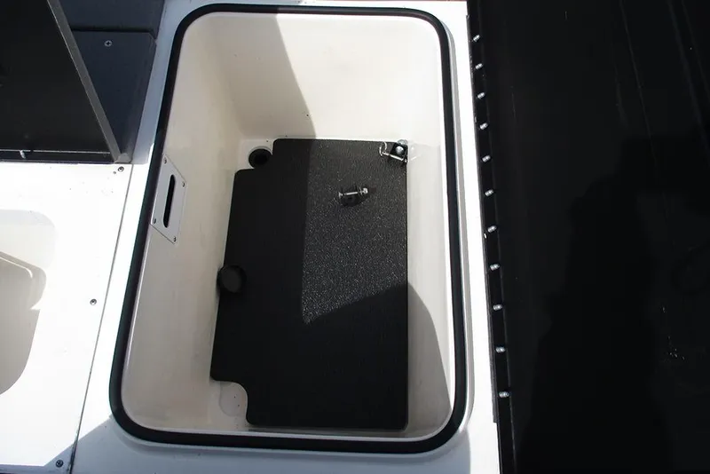 Slide: The Image of Storage compartment of 2021 Vexus AVX 1980 boat, featuring a black mat and latch. - 23