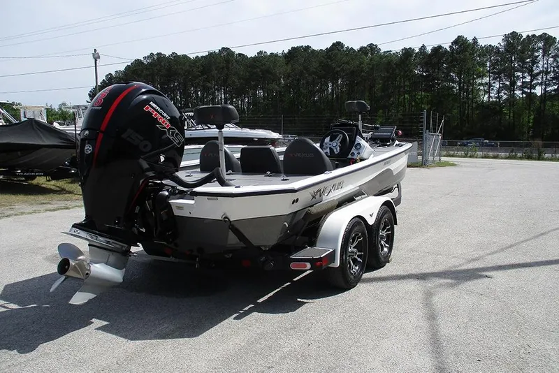 Slide: The Image of 2021 Vexus AVX 1980 boat with Mercury engine on a trailer, parked outdoors. - 9