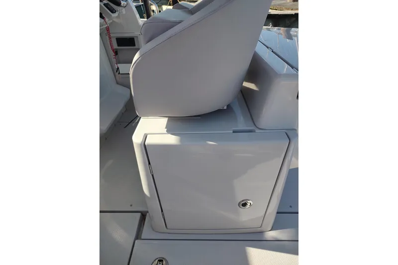 Slide: The Image of 2023 RYCK 280 boat interior with storage compartment and seating. - 33