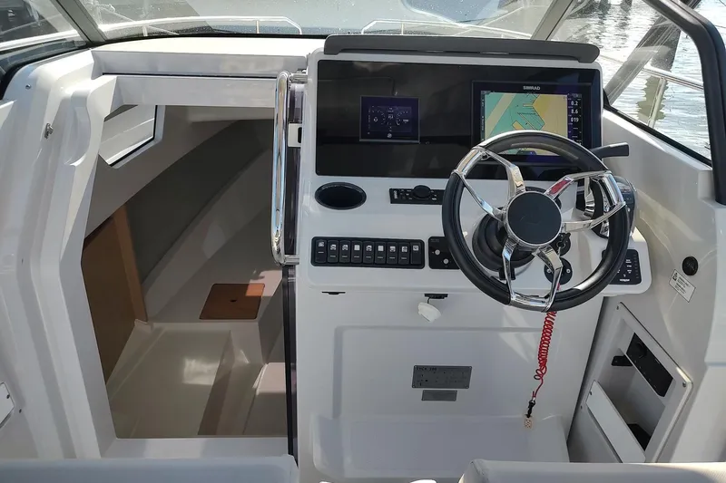 Slide: The Image of Cockpit of 2023 RYCK 280 boat with modern steering and navigation system. - 43