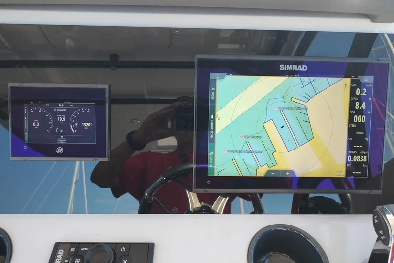 Slide: The Image of Boat dashboard with Simrad navigation display on a 2023 RYCK 280 model. - 23