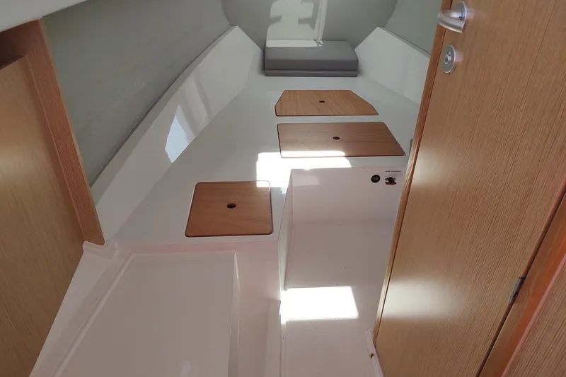 Slide: The Image of Interior cabin of 2023 RYCK 280 boat with wooden accents and storage compartments. - 44