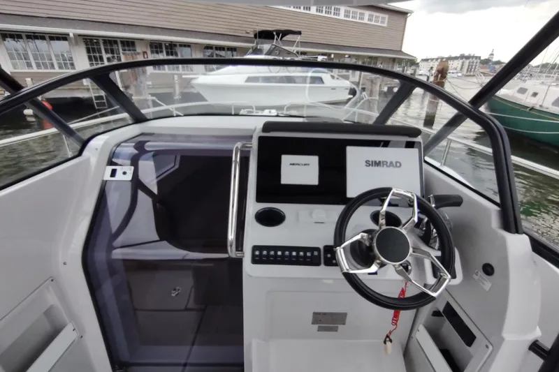 Slide: The Image of Modern 2023 RYCK 280 boat cockpit with steering wheel and navigation displays. - 19