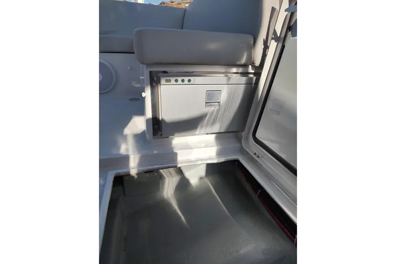 Slide: The Image of Interior of 2023 RYCK 280 boat featuring a compact storage compartment. - 30