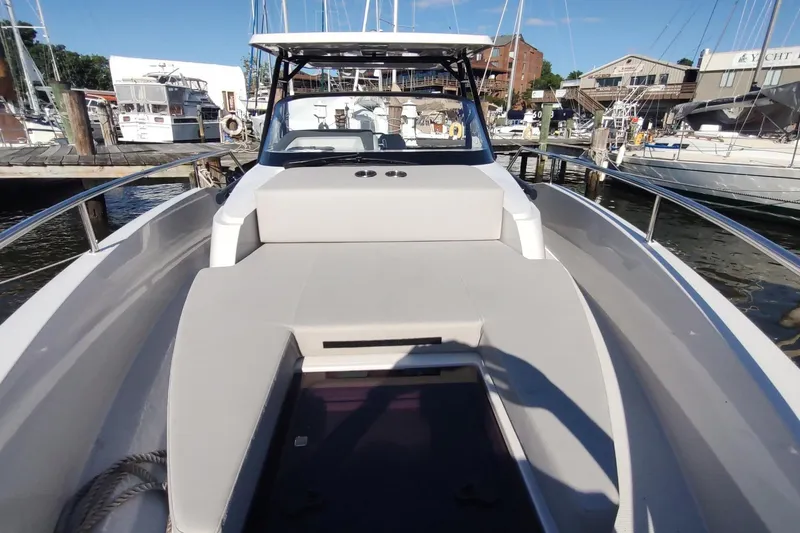 Slide: The Image of 2023 RYCK 280 boat docked at marina, showcasing spacious deck and sleek design. - 37