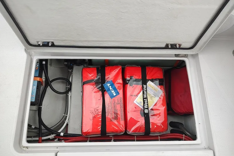Slide: The Image of Storage compartment on a 2023 RYCK 280 boat with safety equipment. - 26