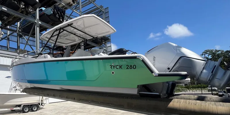 Slide: The Image of 2023 RYCK 280 boat on dry dock with outboard motor. - 3