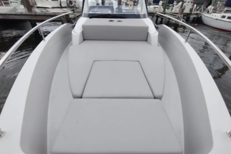 Slide: The Image of 2023 RYCK 280 boat with spacious deck and comfortable seating at a marina. - 38