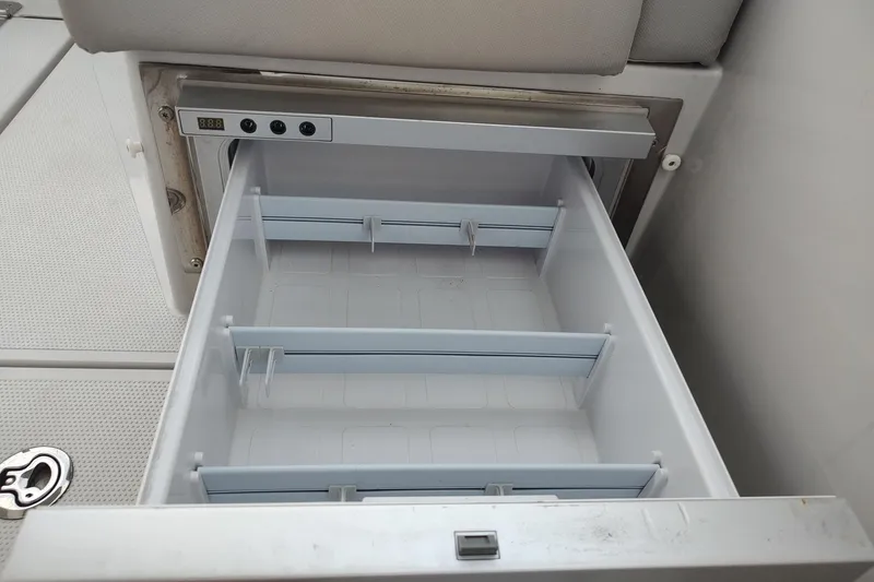 Slide: The Image of Open storage compartment on 2023 RYCK 280 boat, featuring adjustable dividers. - 32