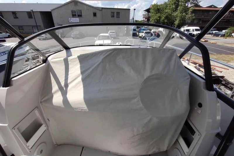 Slide: The Image of RYCK 280 boat cockpit with covered helm, 2023 model, parked in marina. - 56