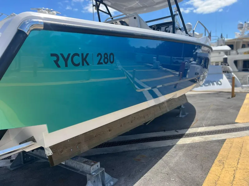 Slide: The Image of RYCK 280 boat 2023, blue design at the harbor. - 7