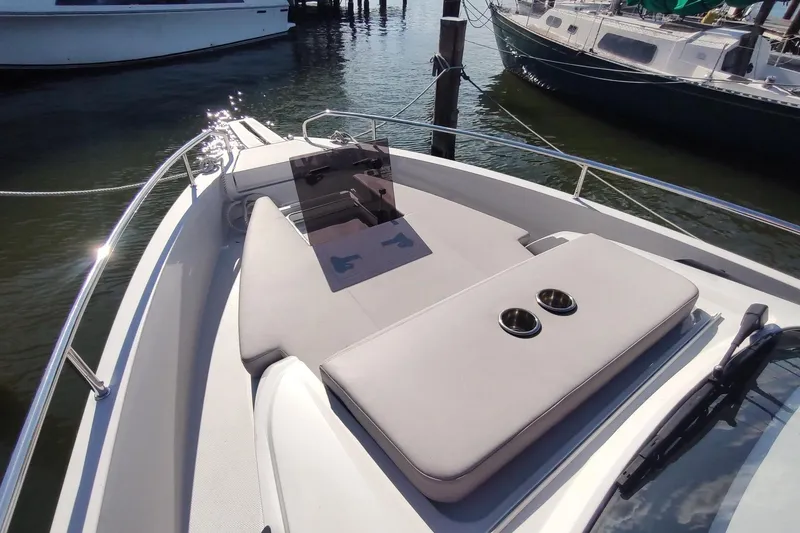 Slide: The Image of 2023 RYCK 280 boat with sunbathing area and cup holders, docked in a marina. - 39