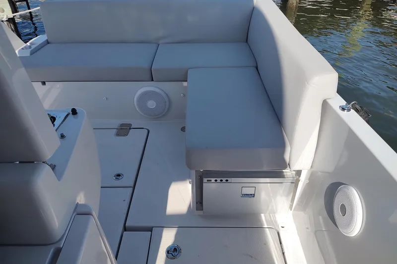 Slide: The Image of Modern RYCK 280 boat interior with cushioned seating, speakers, and storage, 2023 model. - 13