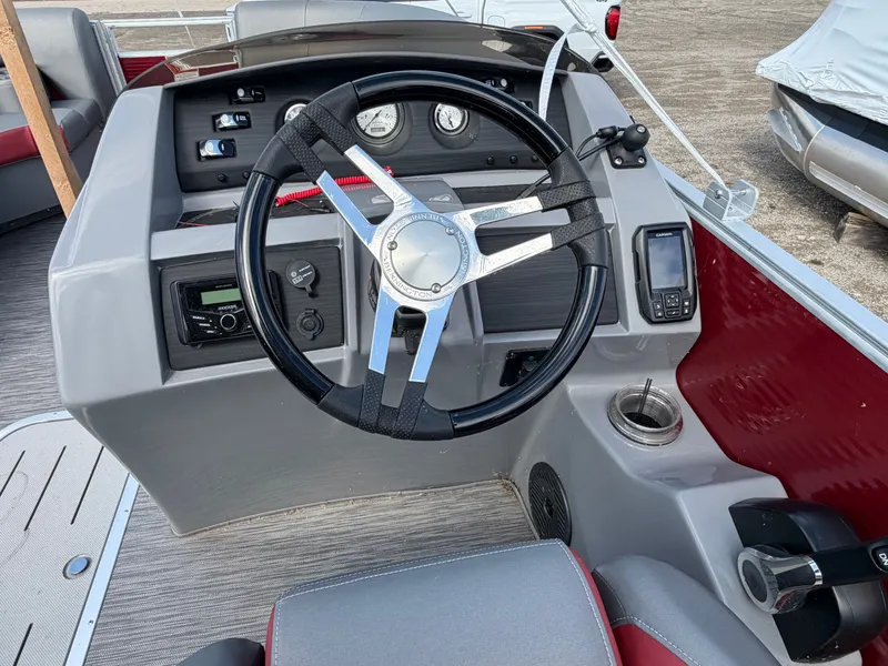 Slide: The Image of Steering wheel and dashboard of a 2022 Bennington 20 LSB boat. - 10
